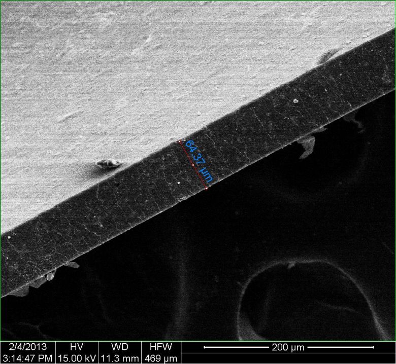 A composite material created at Rice University is nearly impervious to gas and may lead to efficient storage of compressed natural gas for vehicles. A 65-micrometer-wide polymer film, photographed edge-on with an electron microscope, contains a tiny amount of enhanced graphene nanoribbons that present gas molecules a “tortuous path” to escape. (Credit: Changsheng Xiang/Rice University)